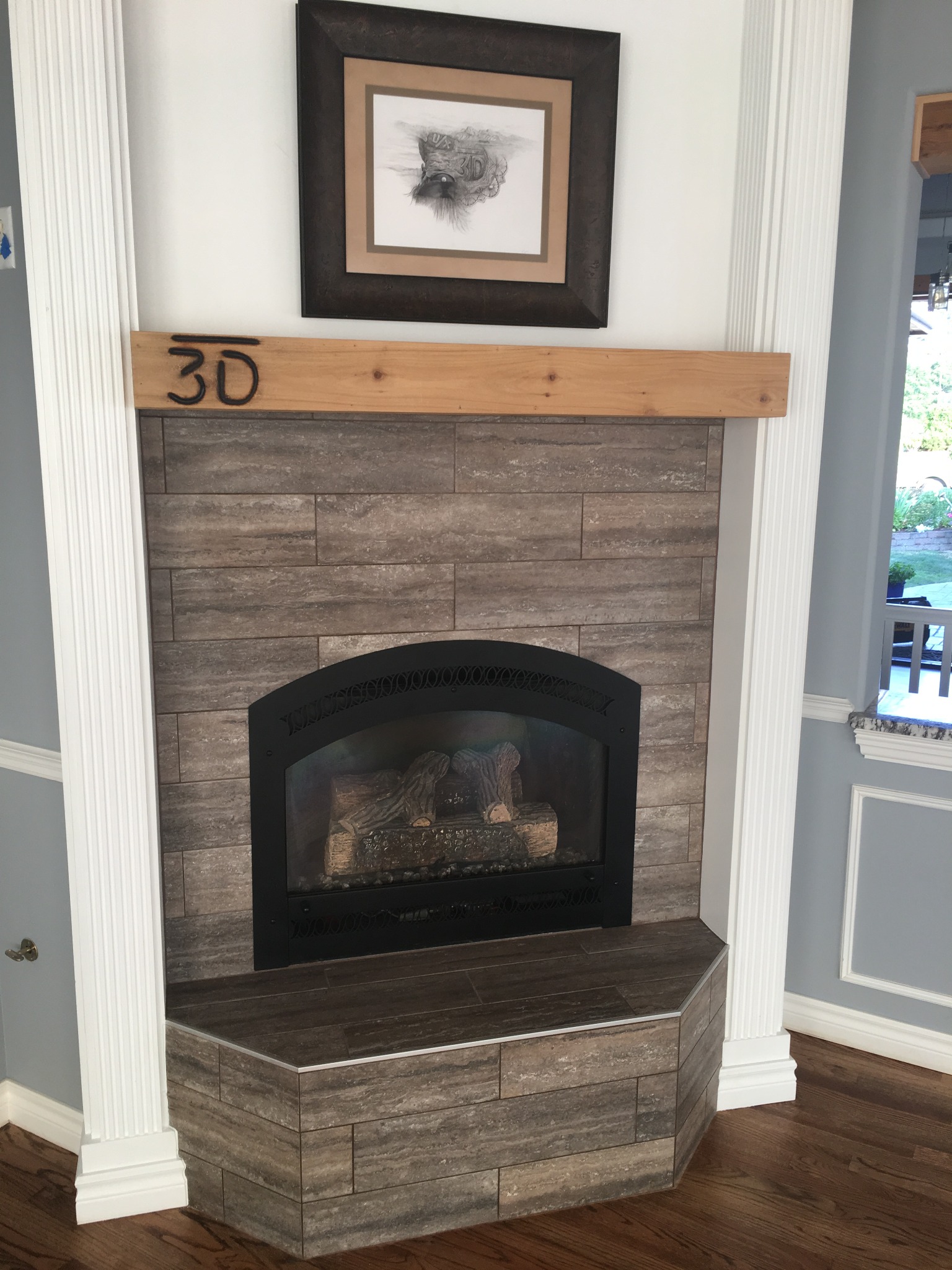 Finished fireplace with tile surround, hearth, and wood mantel