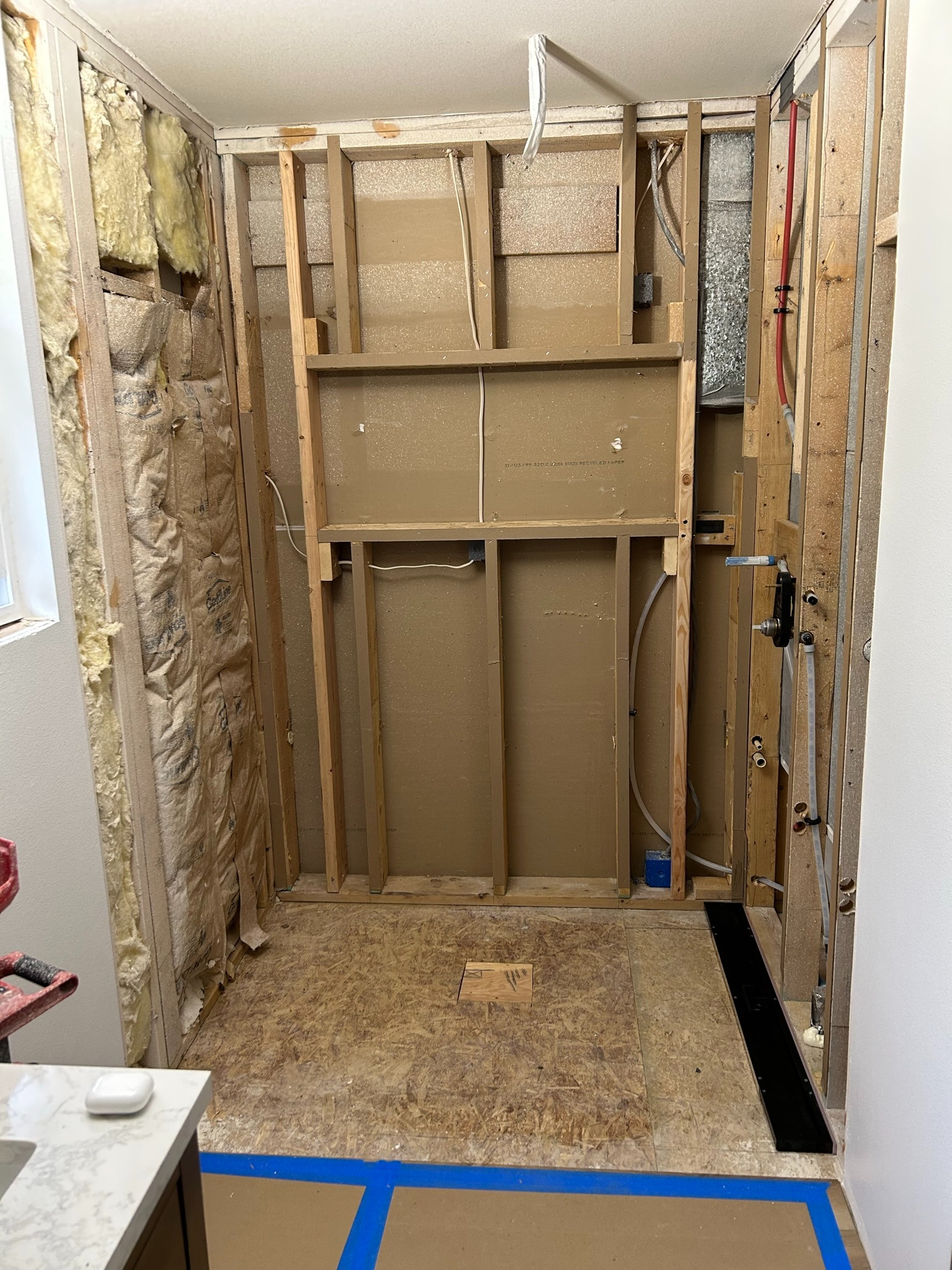 Shower framing and plumbing preparation in progress
