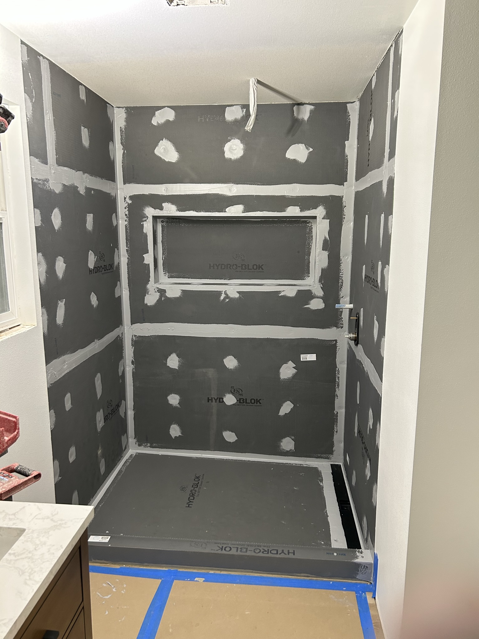 Shower backer board installed with a framed recessed niche