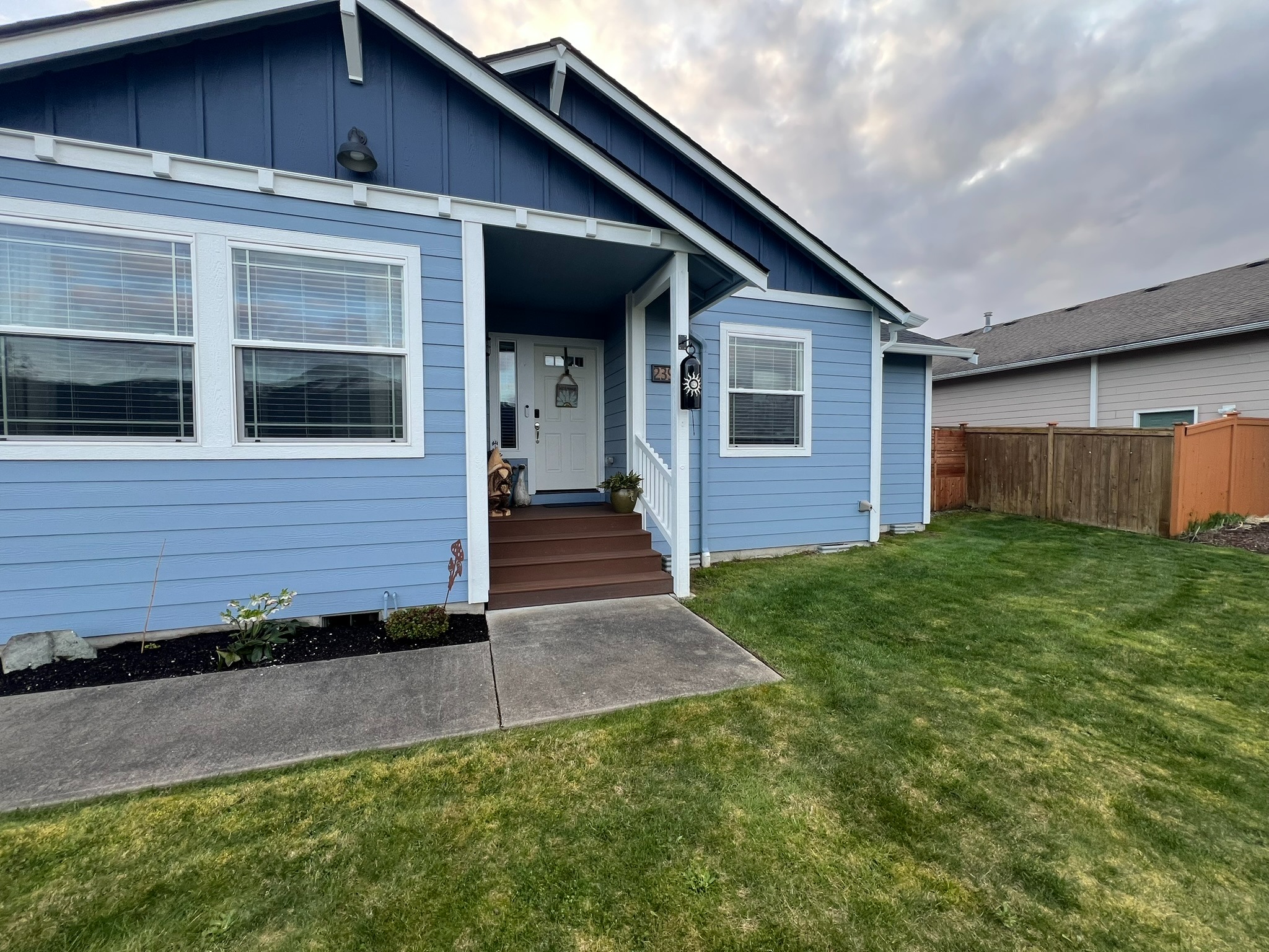 Front exterior of the home beside the completed deck