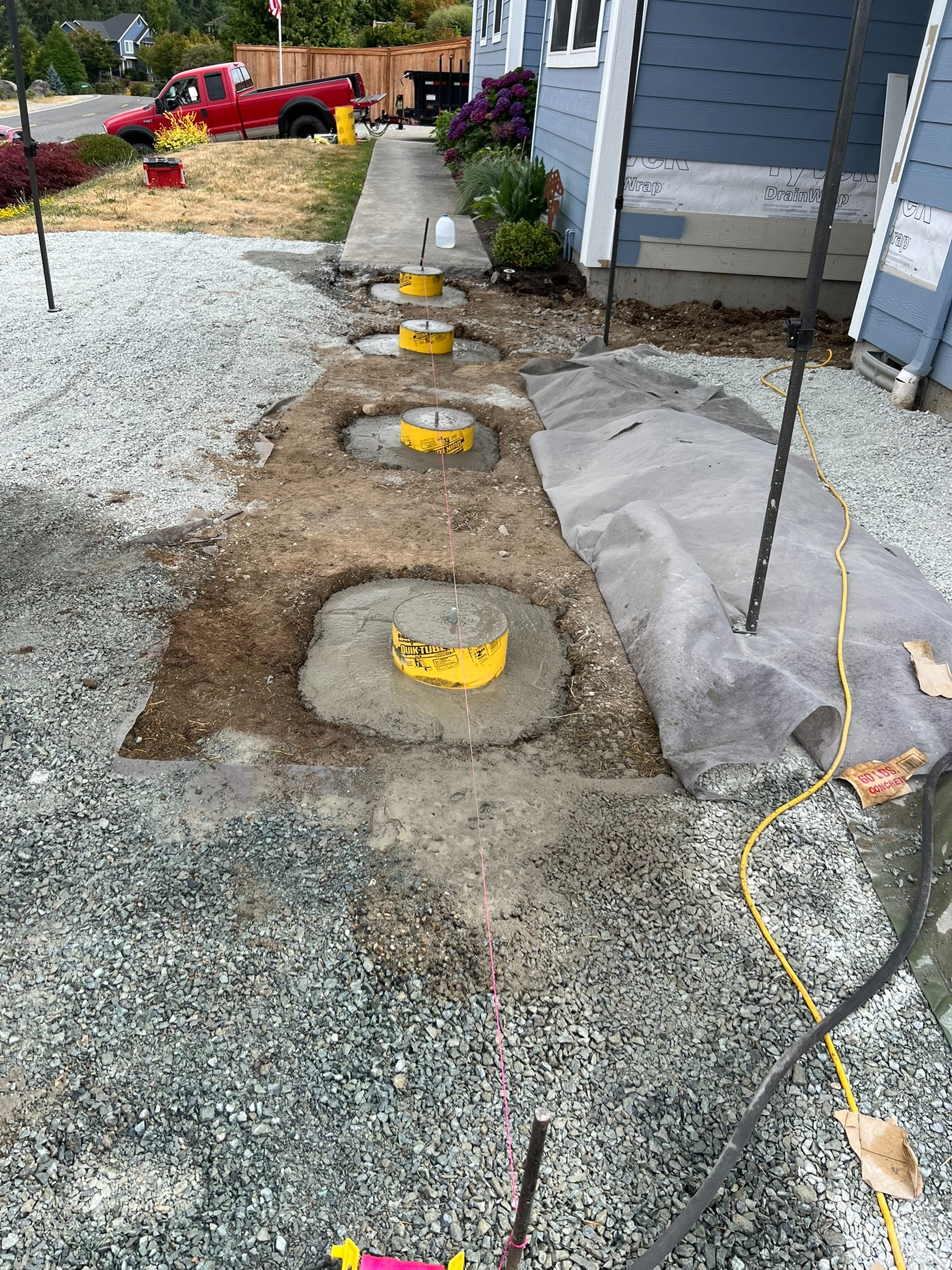 Concrete pier footings prepared for the deck framing