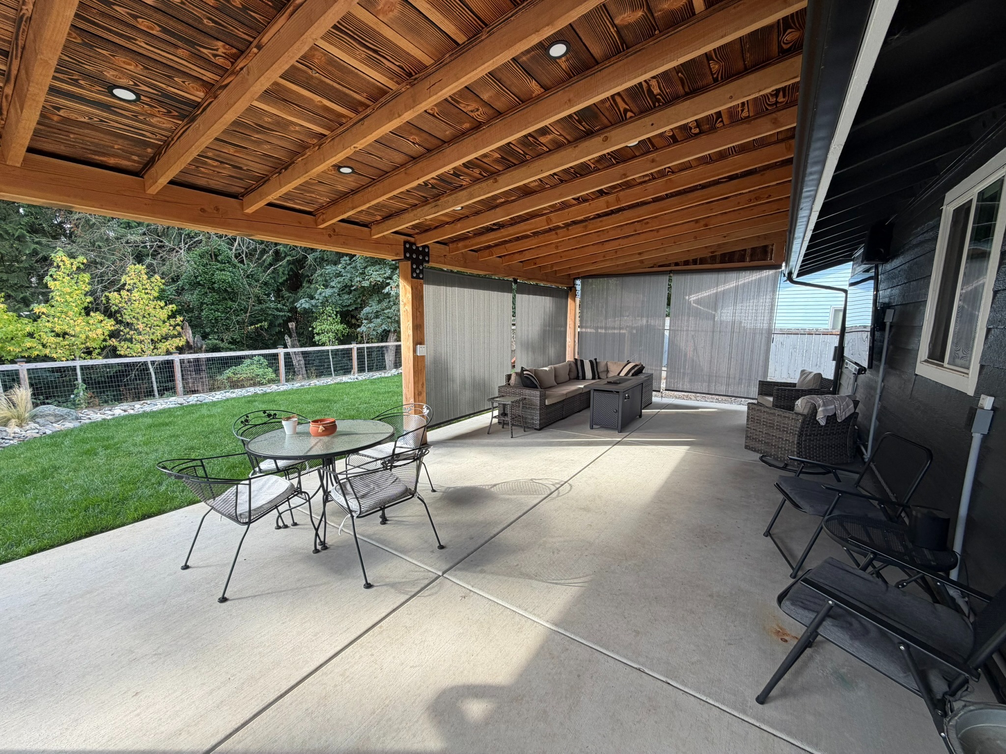 Finished patio cover viewed from beneath the exposed wood framing