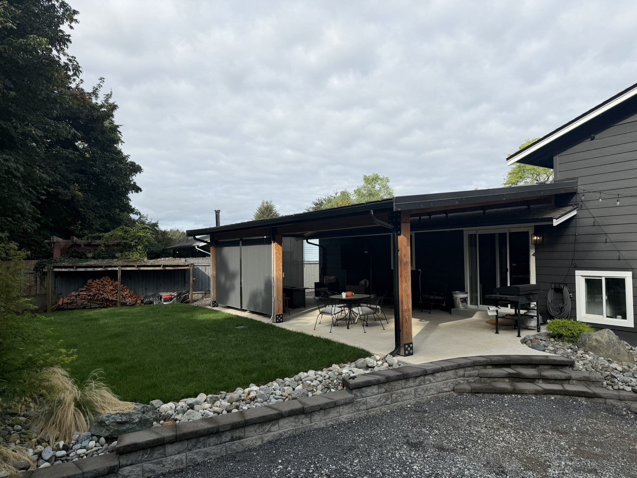 Wide backyard view of the completed covered patio
