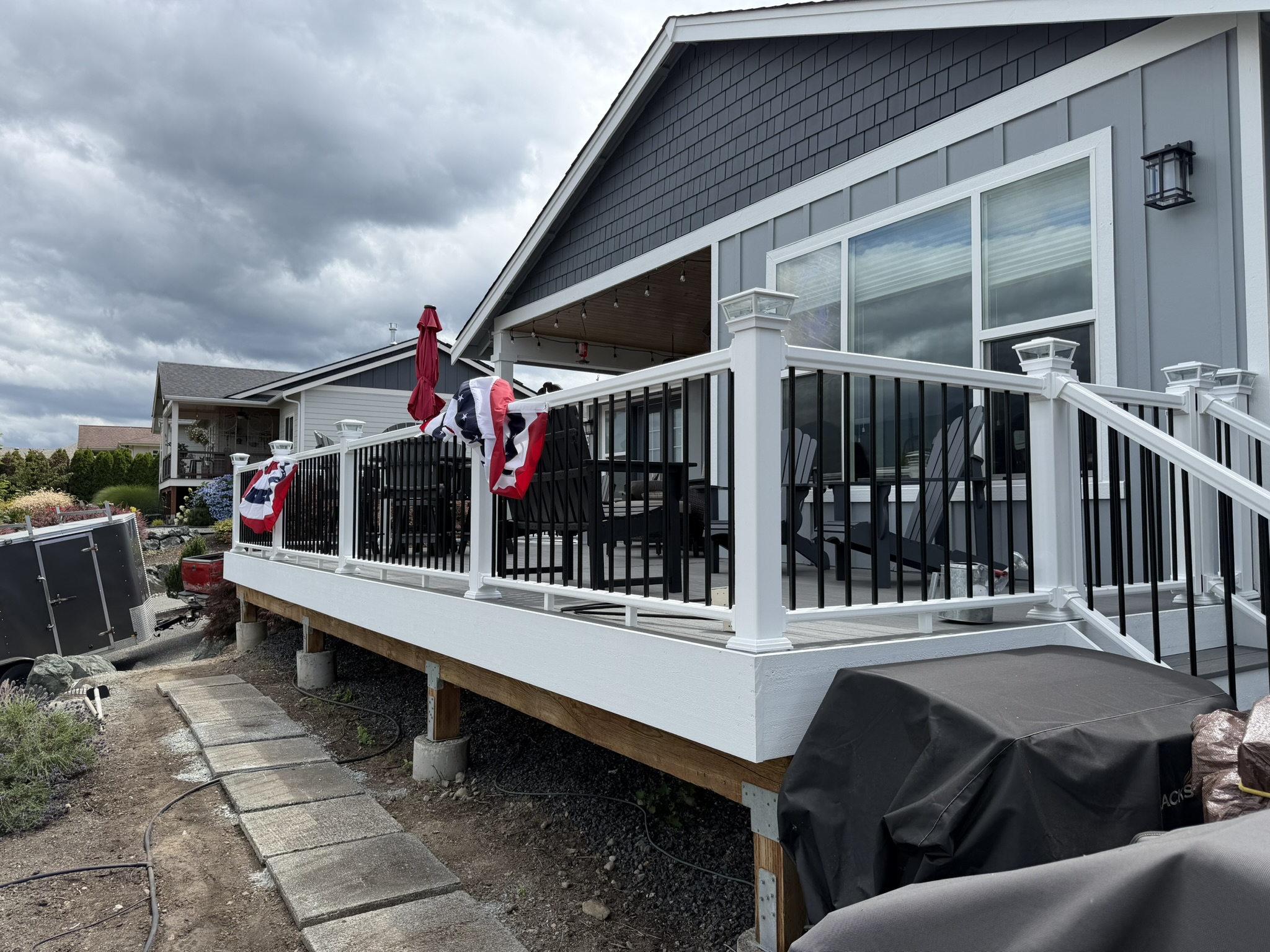 Finished raised deck and stairs with new white and black railing