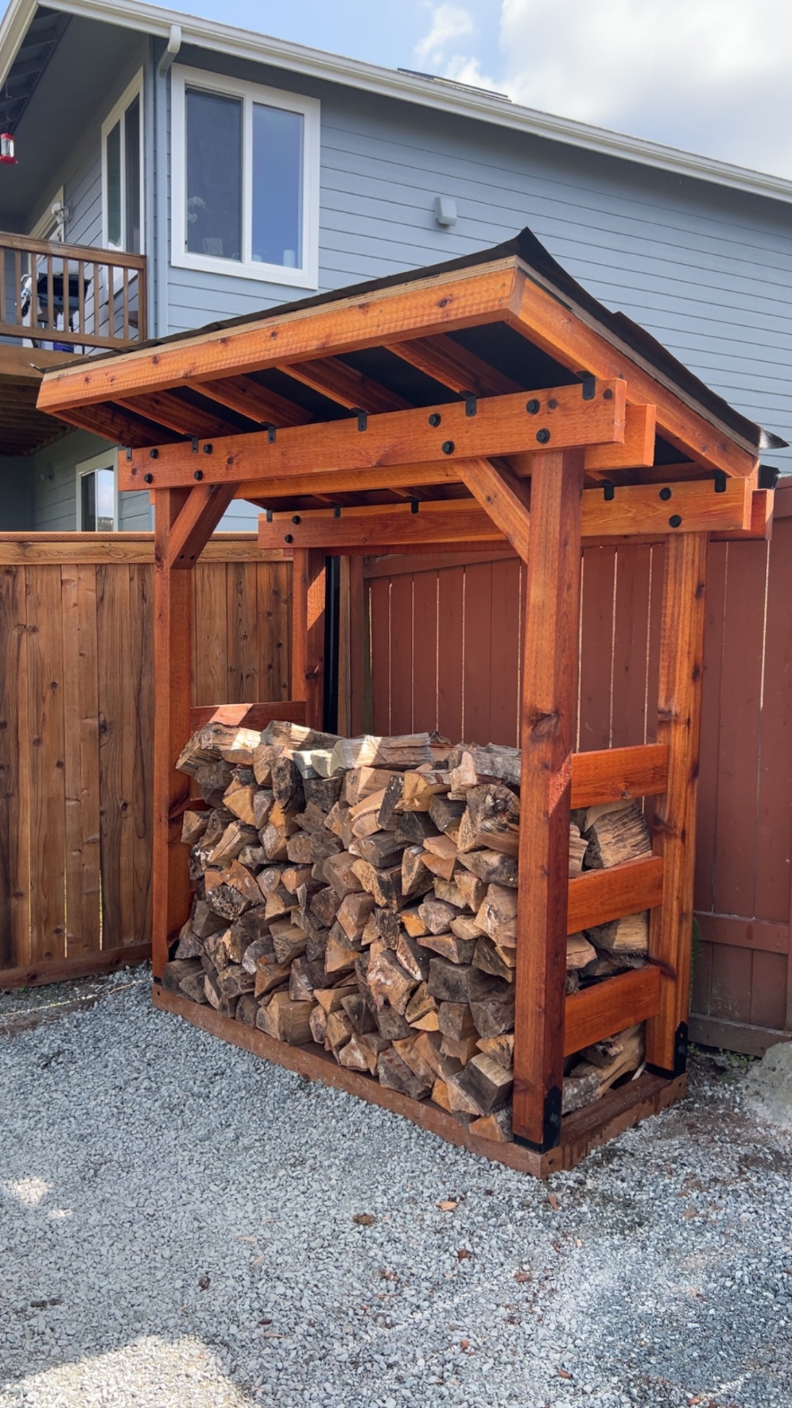 Custom covered outdoor firewood storage structure